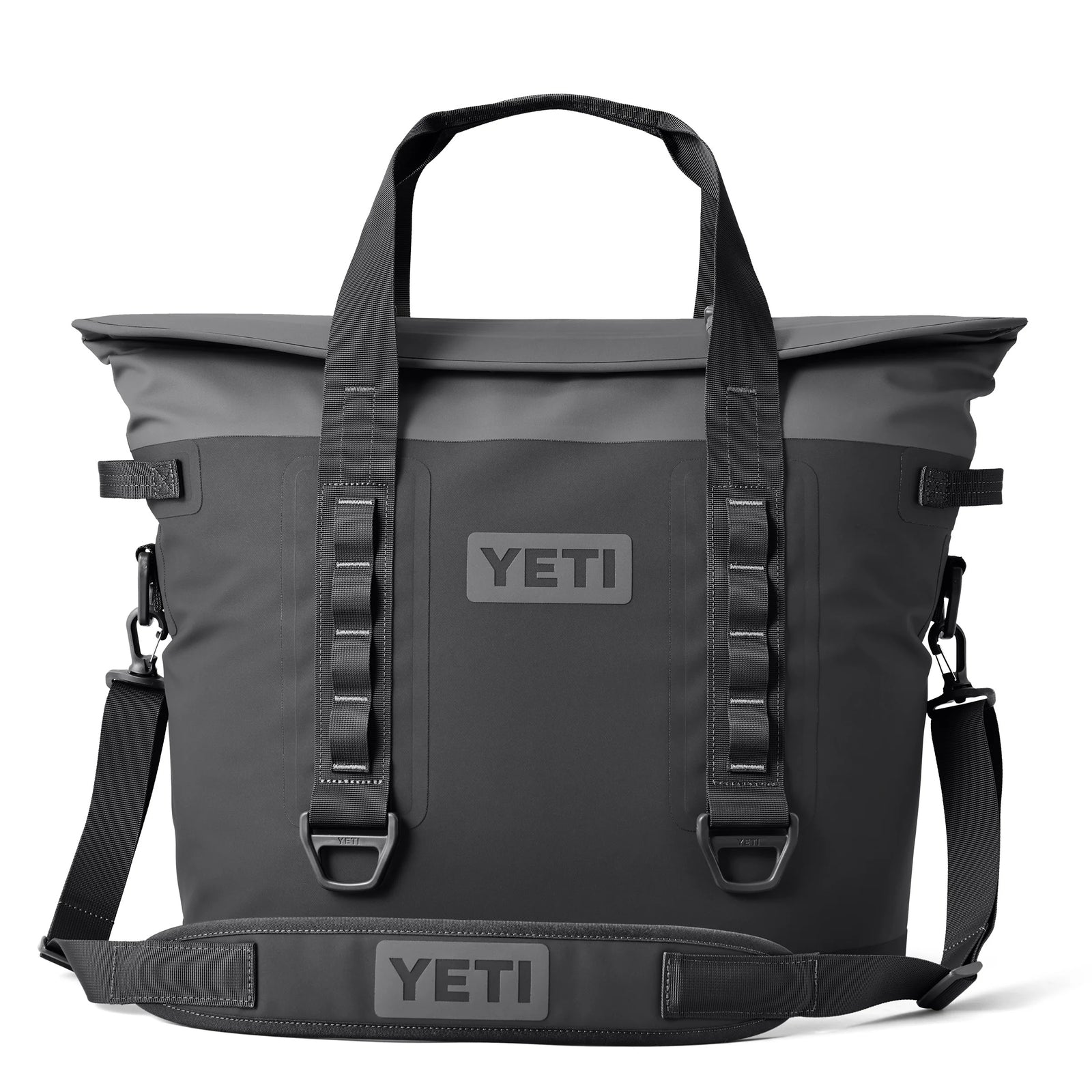 Die YETI® Hopper M30 Soft Cooler in Anthrazit verfügt über zwei Griffe, einen verstellbaren Schultergurt, Schlaufen an der Vorderseite und einen auffälligen YETI-Schriftzug auf der Vorderseite und dem Gurt, der auf weißem Hintergrund abgebildet ist.