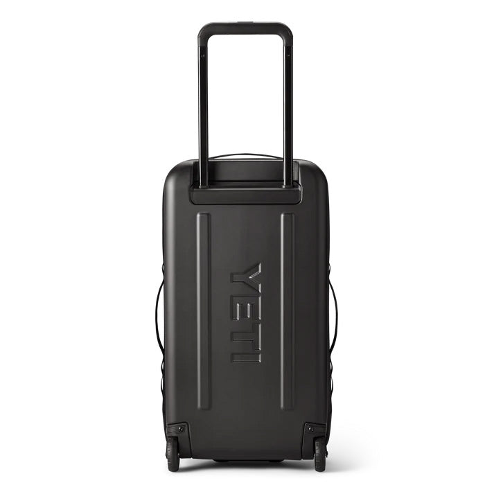 Der YETI® Koffer Crossroads® 29'' in Schwarz verfügt über einen verlängerten Teleskopgriff, ein eingeprägtes YETI-Logo auf der Rückseite, Spinner-Räder und eine robuste Hartschale mit verstärkten Ecken - hier auf weißem Hintergrund.
