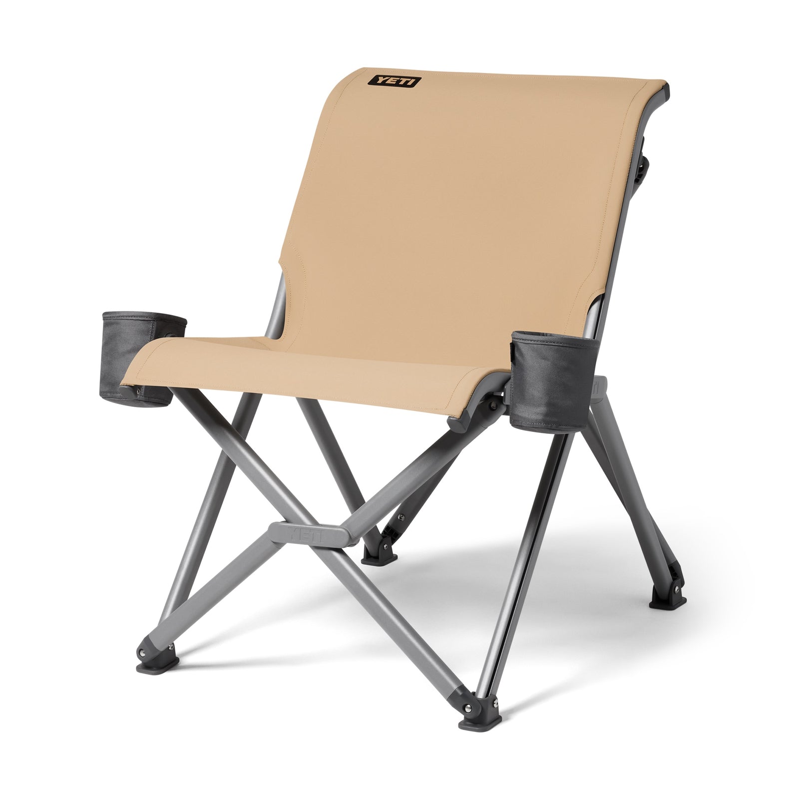 Der YETI® Camping Stuhl Trailhead Field in Tan hat robuste graue Metallbeine, zwei schwarze Becherhalter und das YETI-Logo auf der Rückenlehne - perfekt für Outdoor-Abenteuer. Abgebildet auf einem weißen Hintergrund.