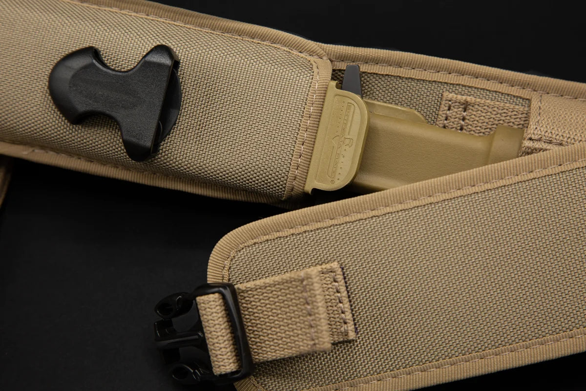Nahaufnahme einer EXTREMA RATIO Messer COL Moschin Desert Warfare tan taktischen Scheide mit strapazierfähigem, genähtem Stoff, schwarzen Kunststoffbeschlägen und einer Kunststoffschnalle, die einen Teil des Einsatzmessergriffs zeigt.