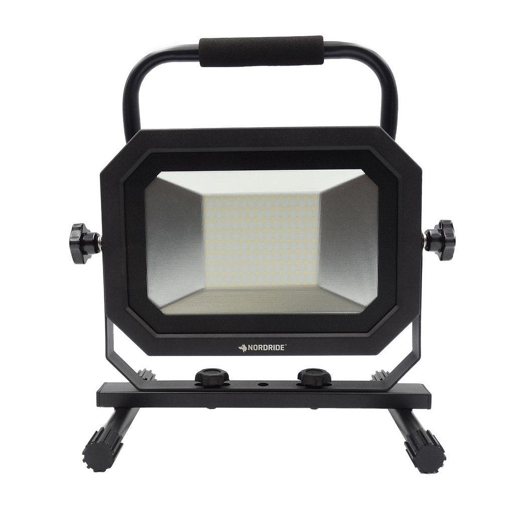 Der Nordride Baustrahler Sector 100W IP65 von NORDRIDE ist ein rechteckiger schwarzer LED-Arbeitsscheinwerfer mit Griff, seitlichen Knöpfen und breitem Sockel - konzipiert für Langlebigkeit und helle Ausleuchtung.