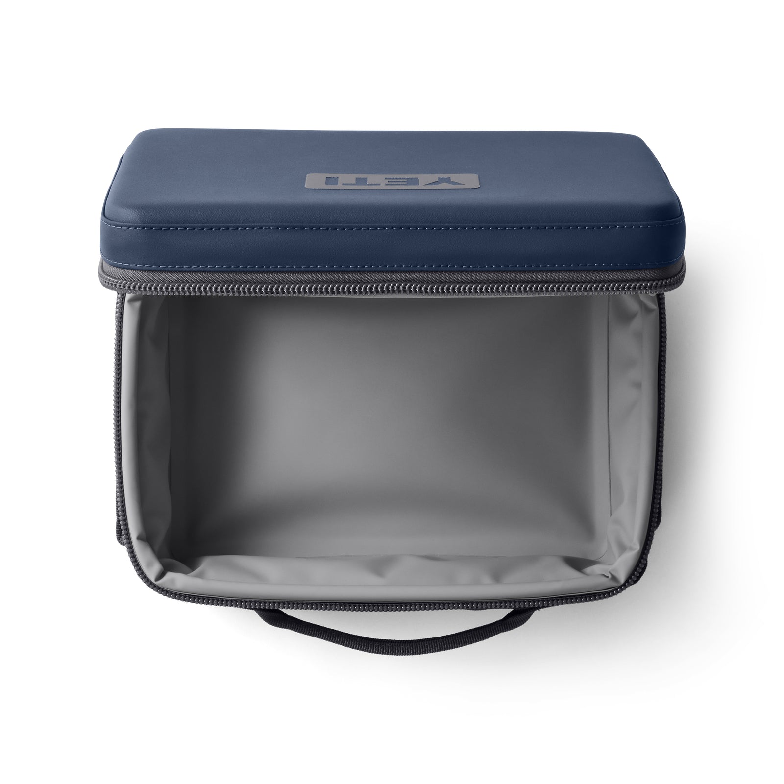 Die YETI® Kühltasche Daytrip Lunch Box 5L - Navy verfügt über einen geräumigen grauen Innenraum, einen grauen Reißverschluss, einen Tragegriff und ein YETI-Logo auf dem Deckel - perfekt als isolierte Lunch-Tasche für jeden Tag.