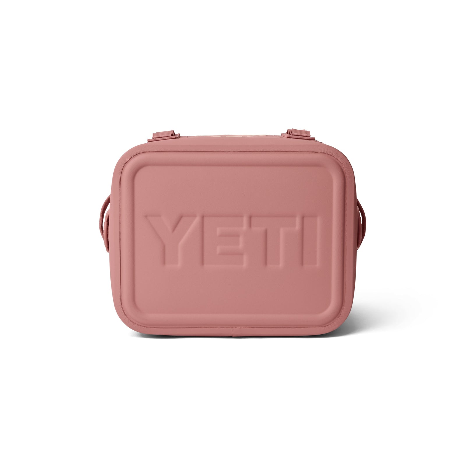 Die YETI® Kühltasche Hopper Flip® 12 - Sandstone Pink ist von vorne auf weißem Hintergrund abgebildet und verfügt über abgerundete Kanten, seitliche Griffe und den eingeprägten YETI-Markennamen.