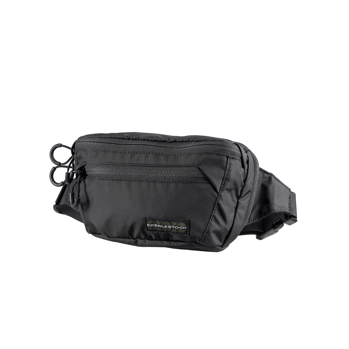 Die EBERLESTOCK Bando Bag Standard ist ein schwarzer taktischer Hüftrucksack mit mehreren Reißverschlussfächern, einem verstellbaren Gurt und einem kleinen Logoanhänger auf der Vorderseite, abgebildet auf einem schlichten weißen Hintergrund.