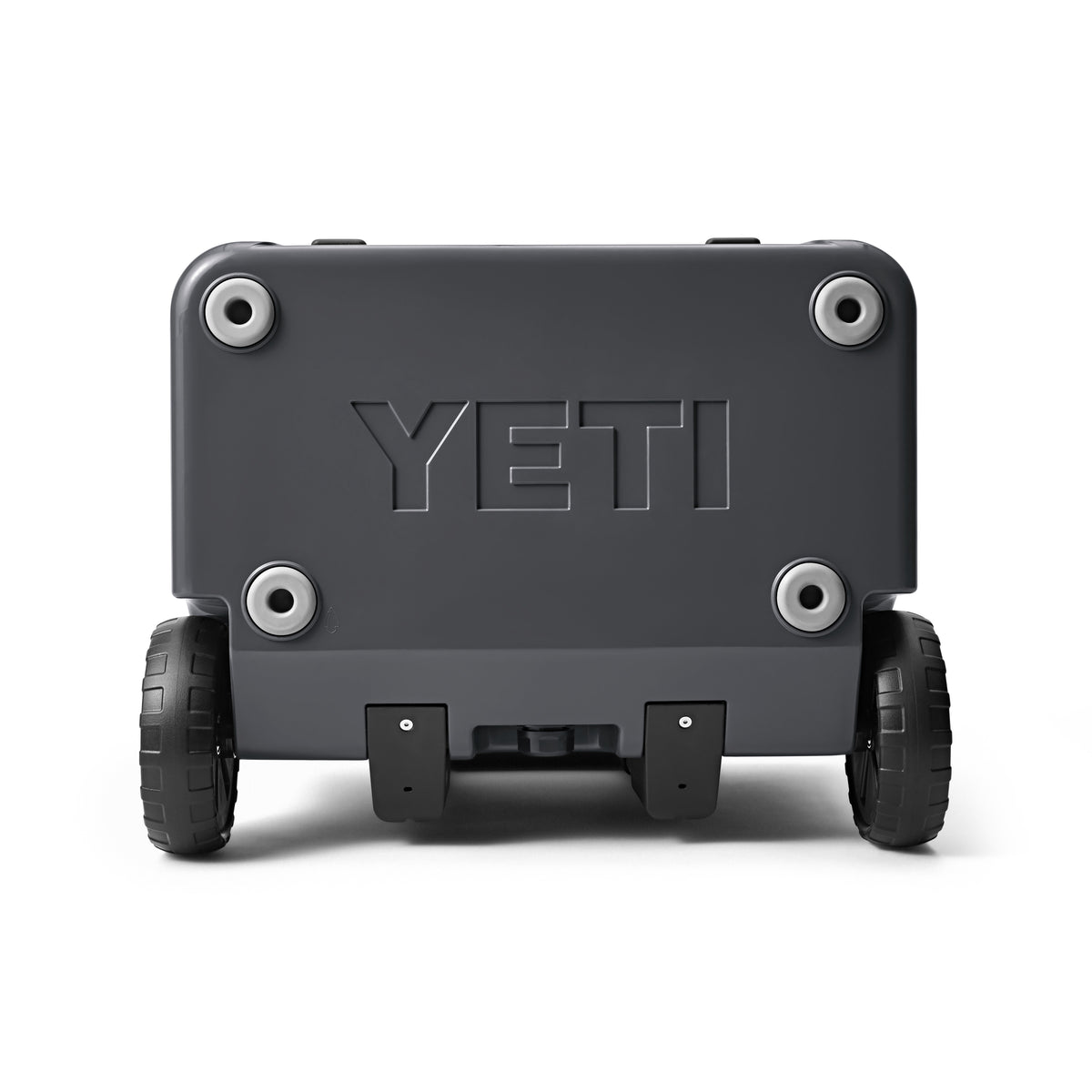 Die robuste, anthrazitfarbene YETI® Kühlbox Roadie 60 mit profilierten Rädern und stabilen Bodengriffen, auf deren Seite "YETI" eingeprägt ist, ist auf dem Bild von unten zu sehen.
