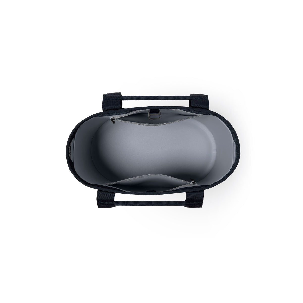 Draufsicht auf die YETI® Tragetasche Camino® Carryall 35 – Classic Navy, eine robuste Allzwecktasche mit schwarzen Tragegriffen, hellgrauem Innenfutter, einer Reißverschlusstasche und einer offenen Innentasche.
