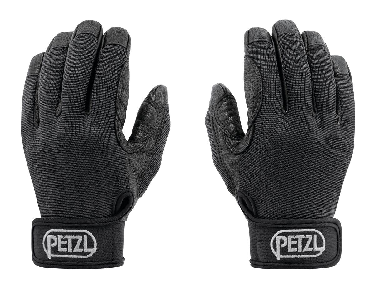 Ein Paar schwarze PETZL Handschuh Cordex Handschuhe mit verstärkten Handflächen und Klettverschlüssen an den Handgelenken, die Handflächen zeigen nach außen. Das PETZL-Logo erscheint auf beiden Riemen - perfekte Handschuhe zum Sichern.