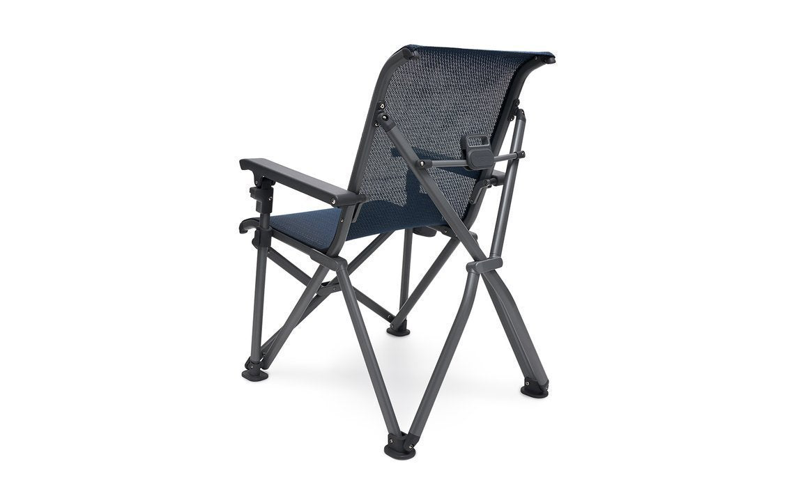 Der YETI® Camping Stuhl Trailhead - Navy überzeugt mit stabilem, dunklem Metallrahmen, blauem Mesh-Stoff, Armlehnen und gekreuzten Beinen - perfekt für Outdoor-Abenteuer. Von hinten im Winkel auf weißem Hintergrund gezeigt.