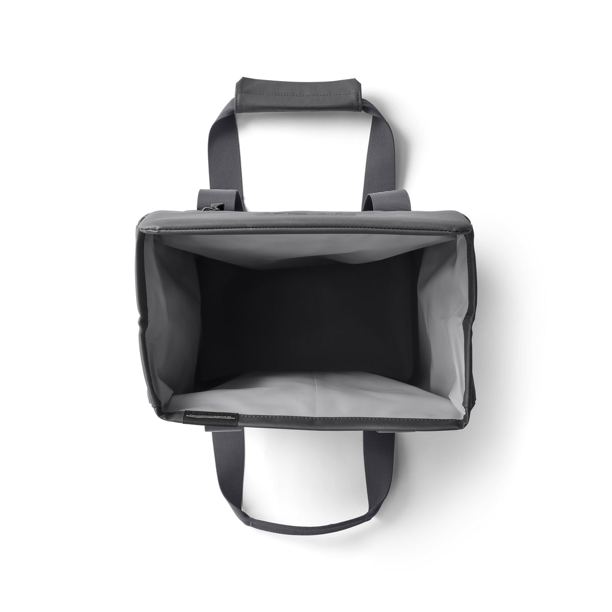 Draufsicht auf eine leere, rechteckige YETI® Kühltasche Daytrip Lunch Bag 14L - Charcoal mit zwei Griffen und einem strukturierten, offenen Innenraum mit Coldcell Flex Isolierung, vor weißem Hintergrund.
