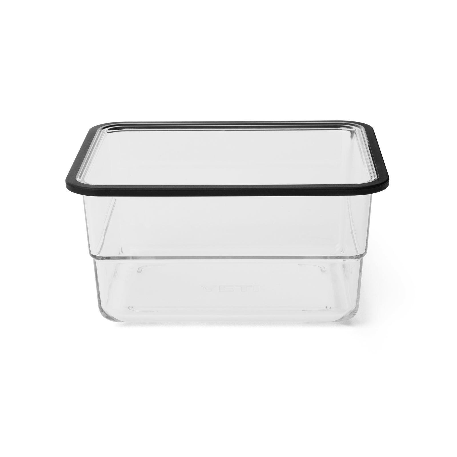 Ein durchsichtiger, rechteckiger YETI® Roadie Cooler Basket - Small mit einem schwarz umrandeten, transparenten Deckel, der den organisierten Stil der YETI-Kühlboxen widerspiegelt, steht auf einem weißen Hintergrund.